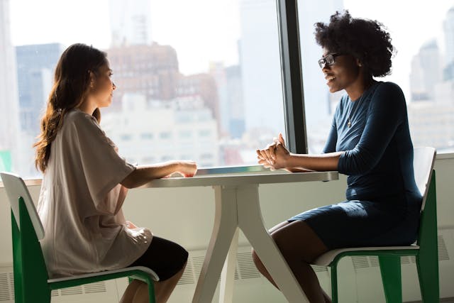 pexels-divinetechygirl-1181719 Women sitting at a table and talking